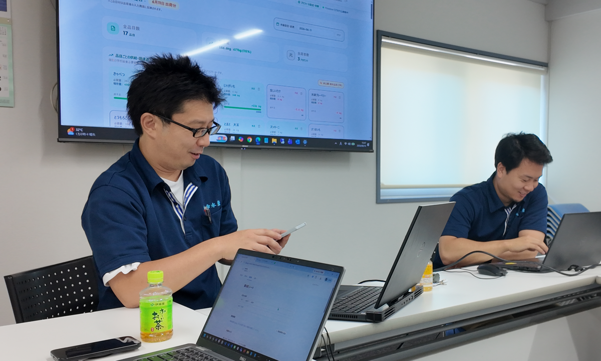 スマートフォンで出荷管理アプリの画面を確認する様子